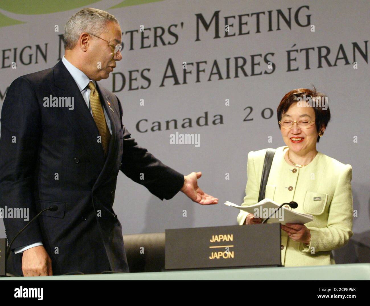 United States Secretary of State Colin Powell helps Japanese Foreign Minister Yoriko Kawaguchi to her seat prior to a closing news conference at the G8 Foreing Ministers meeting in Whistler, British Columbia June 13, 2002. The ministers held two days of talks just ahead of the G8 Leaders meeting later this month. REUTERS/Andy Clark  AC Stock Photo