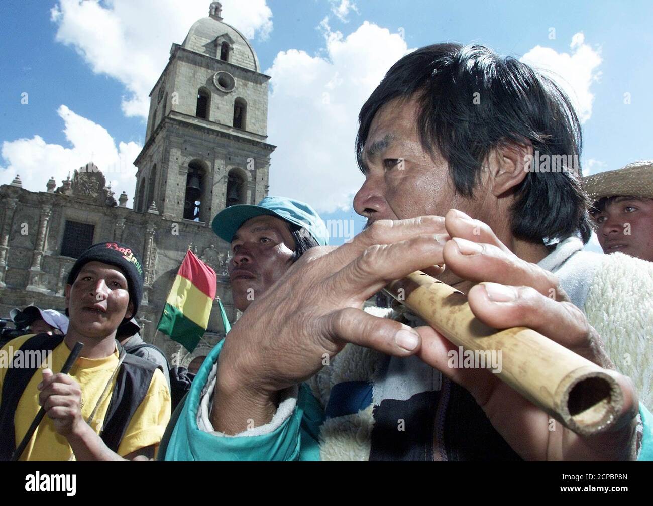 Members of a Guarayo ethnic group play their instruments in the center of La Paz, June 20, 2002. Thousands of farmers and ethnic groups from different parts of the country arrived at the seat of government to demand an agreement to reform the Bolivian constitution, 10 days before presidential elections are held. REUTERS/David Mercado  DM/HB Stock Photo