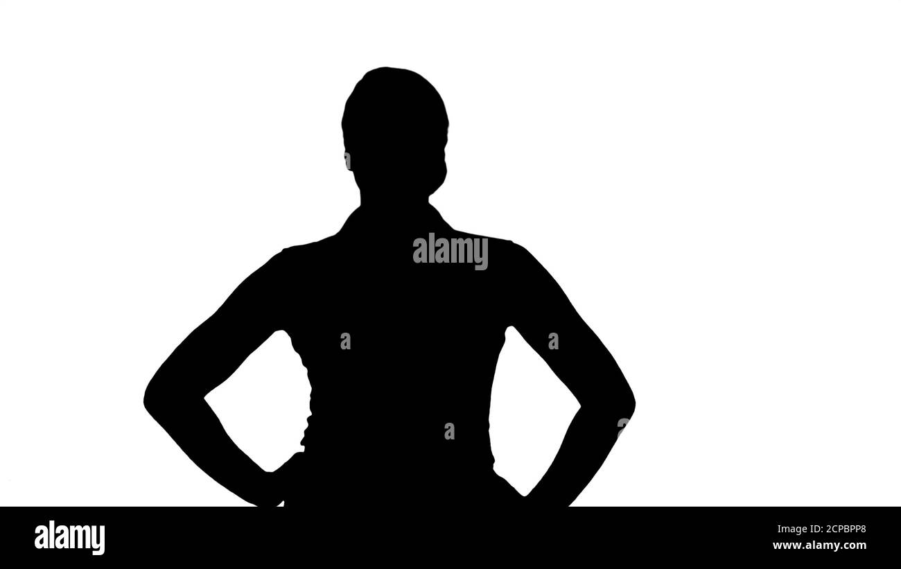 Silhouette Confident young pretty waitress walking with hands on Stock Photo