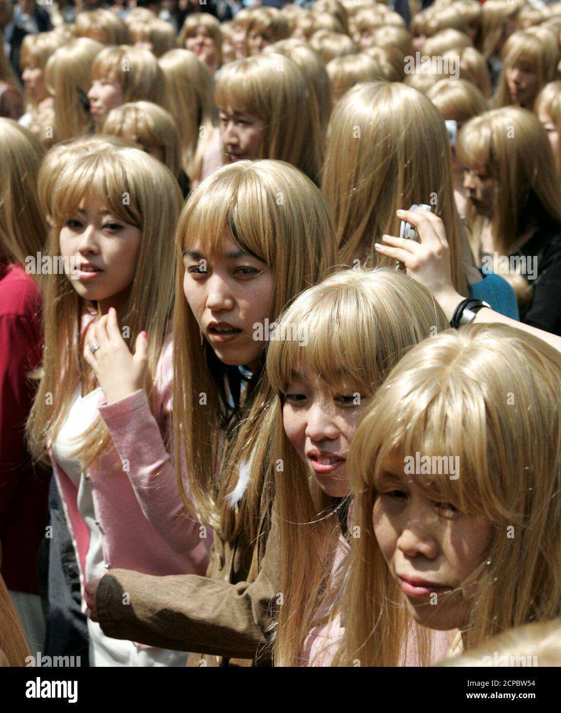 Japanese women wearing blonde wigs take part in a promotional event in  Tokyo April 10, 2005. About 300 Japanese women in identical blonde wigs  took part in the event on Sunday before