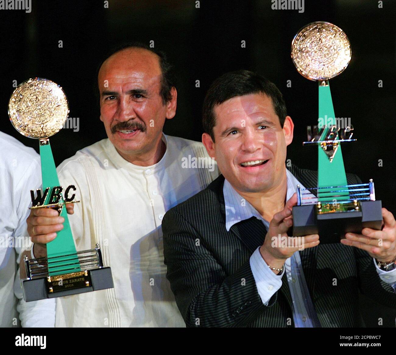 Former boxer Julio Cesar Chavez from Mexico (R) and compatriot Carlos Zarate  hold up their trophy at the World Boxing Council, "WBC's Night of Champions  Event" at the Xcaret park in Cancun