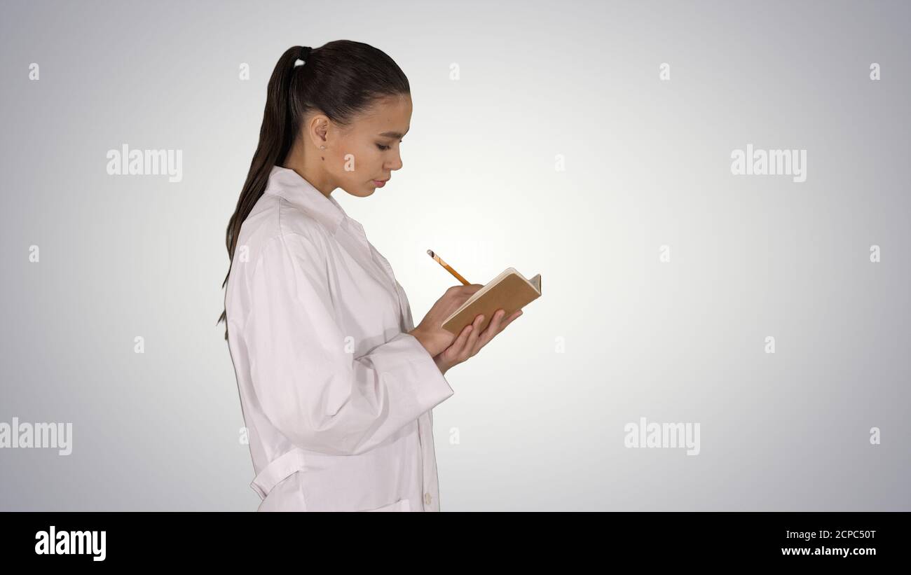 Successful medical doctors making notes while walking on gradien Stock Photo