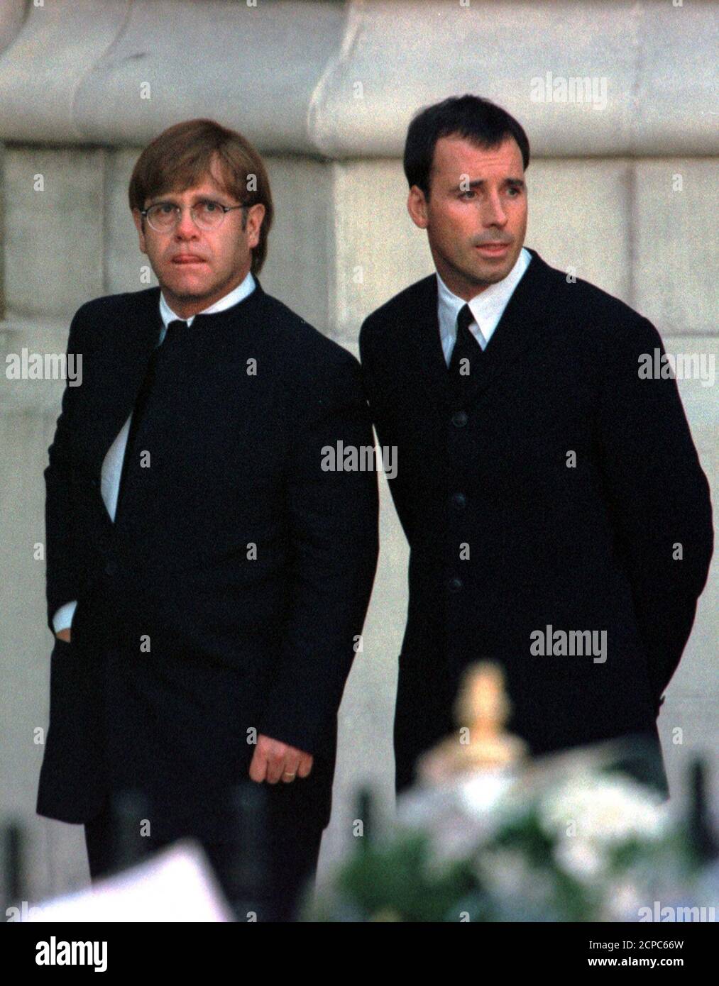 Pop singer Elton John (L), accompanied by companion David Furnish, arrives  at Westminster Abbey for the funeral service for Diana, Princess of Wales,  September 6. John sang a specially re-written version of