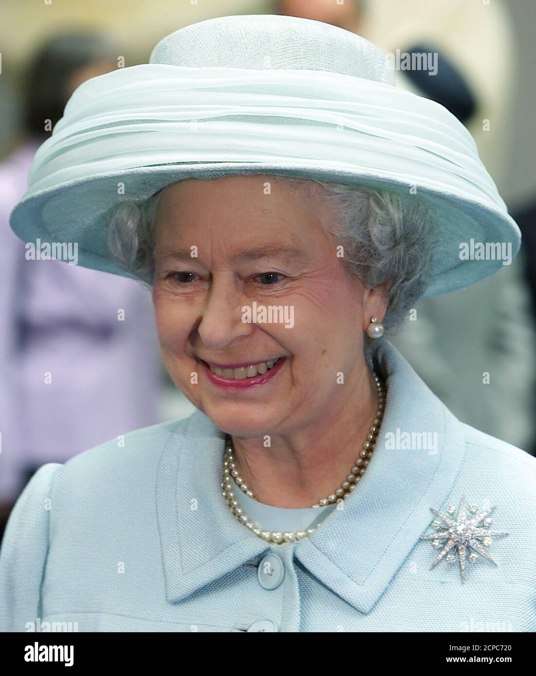 British Queen Elizabeth smiles during the opening ceremony of the new British embassy in Berlin July 18. The new embassy designed by British architect Michael Wilford is based on the same site as the old building which was destroyed by Allied bombers in World War Two.  MUR Stock Photo