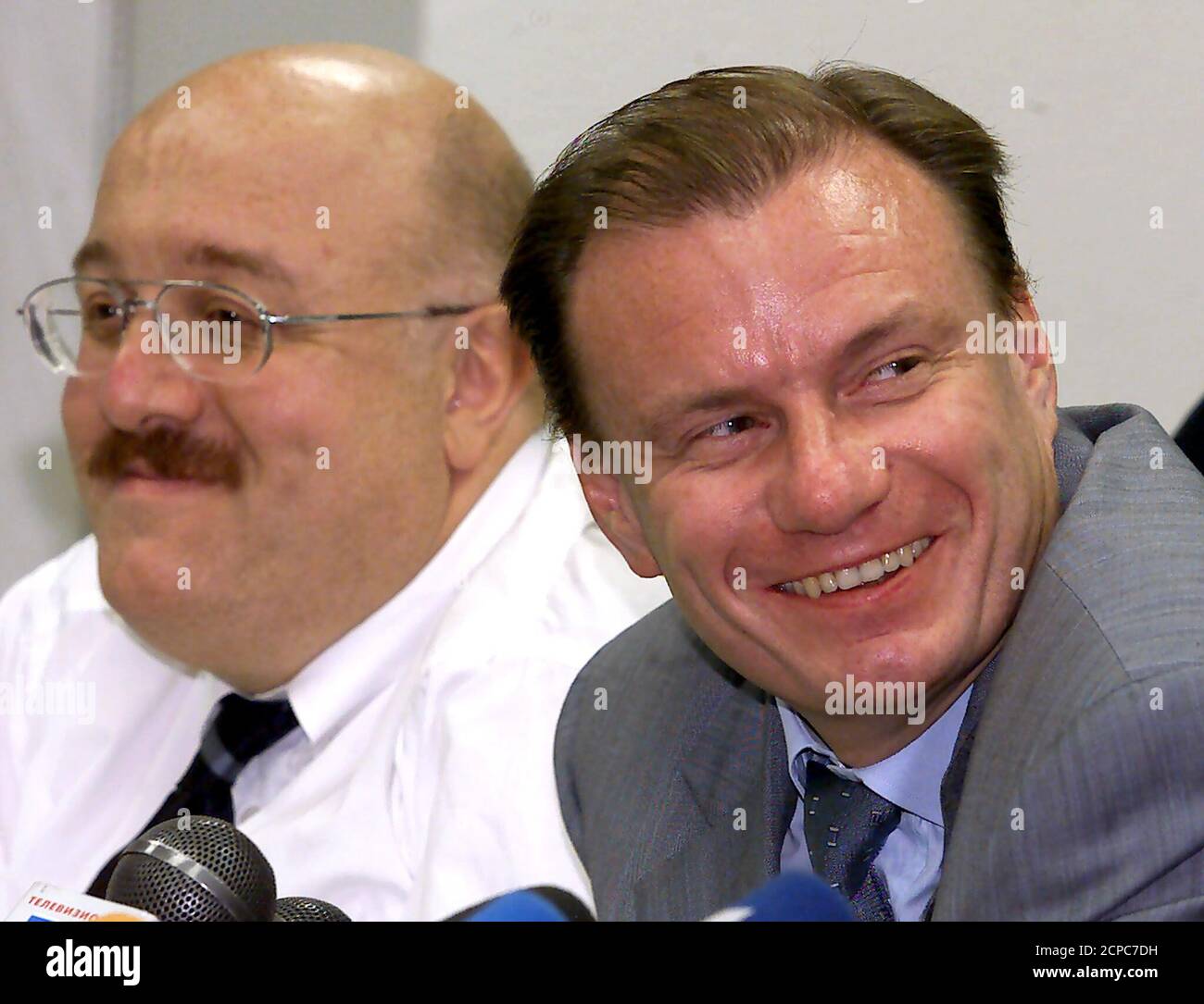Vladimir Potanin (R), head of Interros holding company, and Kakha Bendukidze, president of heavy equipment maker Uralmash, smile as they answer journalists's question at a news conference in Moscow, July 28, 2000. The two businessmen had earlier attended a meeting with President Vladimir Putin and 19 other members of Russian business elite.  WAW/AA Stock Photo