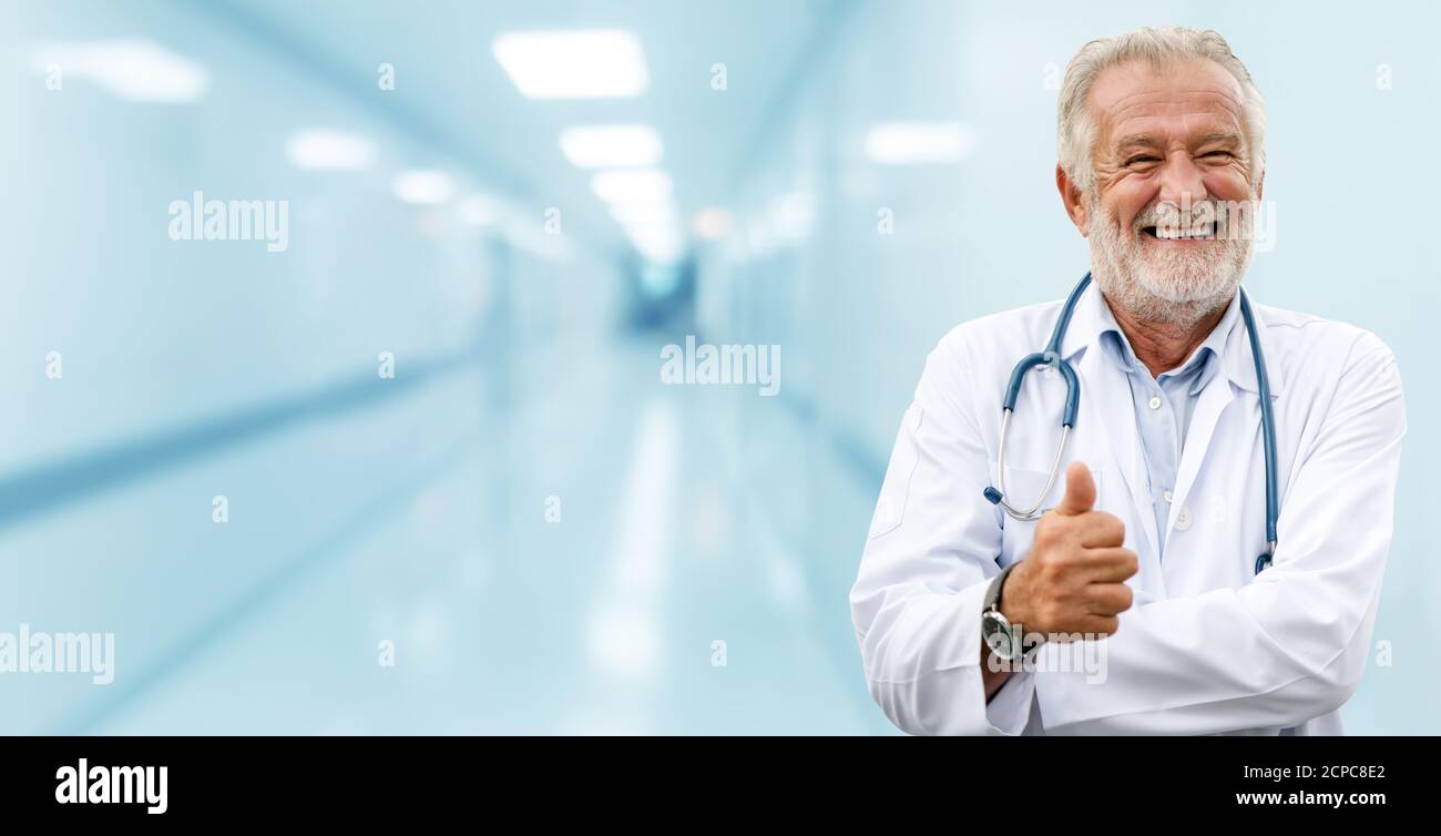 Happy senior doctor standing in the hospital. Medical healthcare