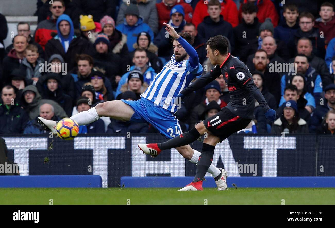 Soccer Football - Premier League - Brighton & Hove Albion vs Arsenal - The American Express Community Stadium, Brighton, Britain - March 4, 2018   Arsenal's Mesut Ozil in action with Brighton’s Davy Propper    REUTERS/Eddie Keogh    EDITORIAL USE ONLY. No use with unauthorized audio, video, data, fixture lists, club/league logos or 'live' services. Online in-match use limited to 75 images, no video emulation. No use in betting, games or single club/league/player publications.  Please contact your account representative for further details. Stock Photo
