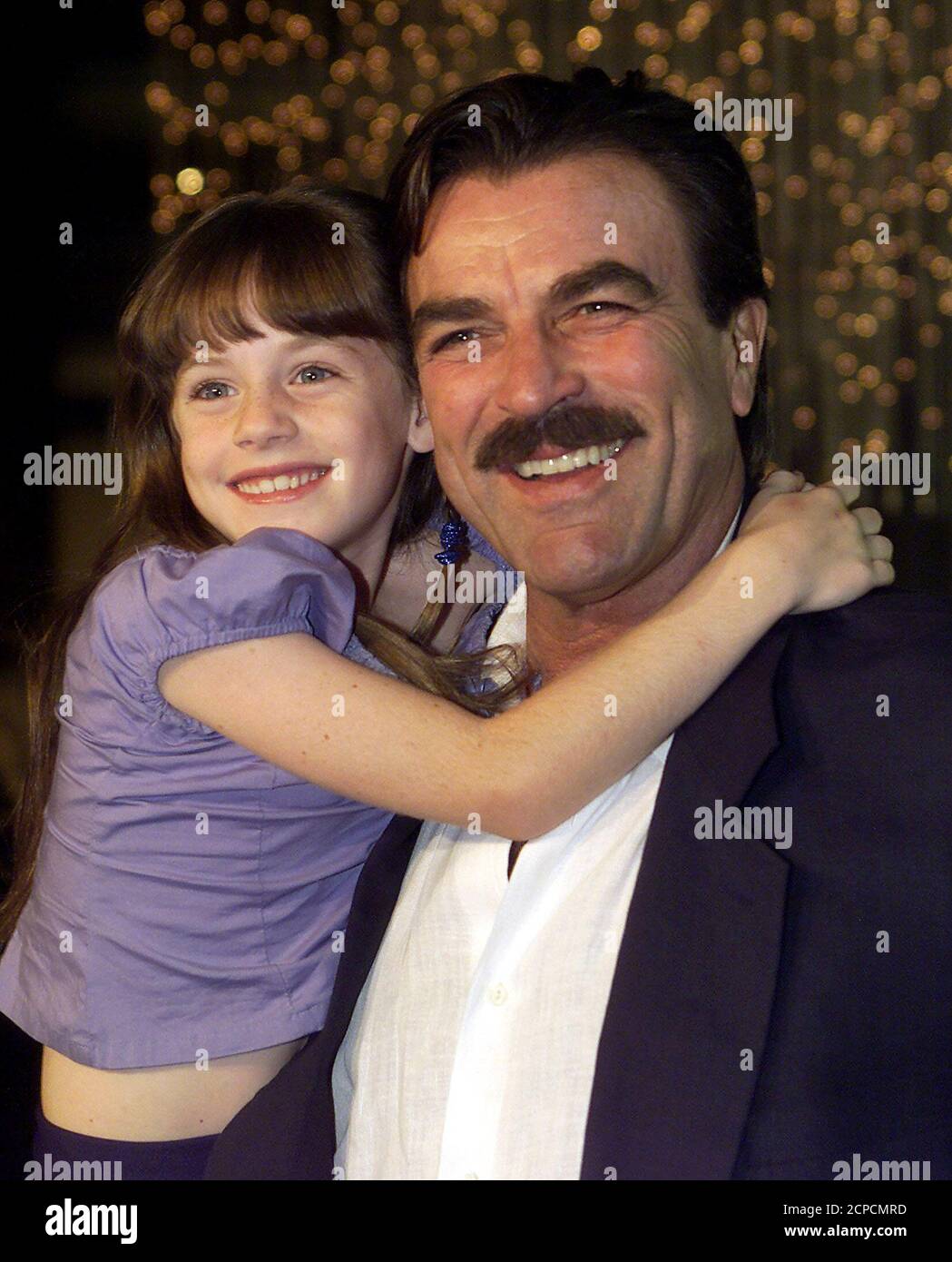 Tom Selleck poses with actress Steffani Brass, 8, at the premiere of the  TNT movie Running Mates, on August 1, 2000, at the Directors Guild of  America Theater in Los Angeles. Selleck