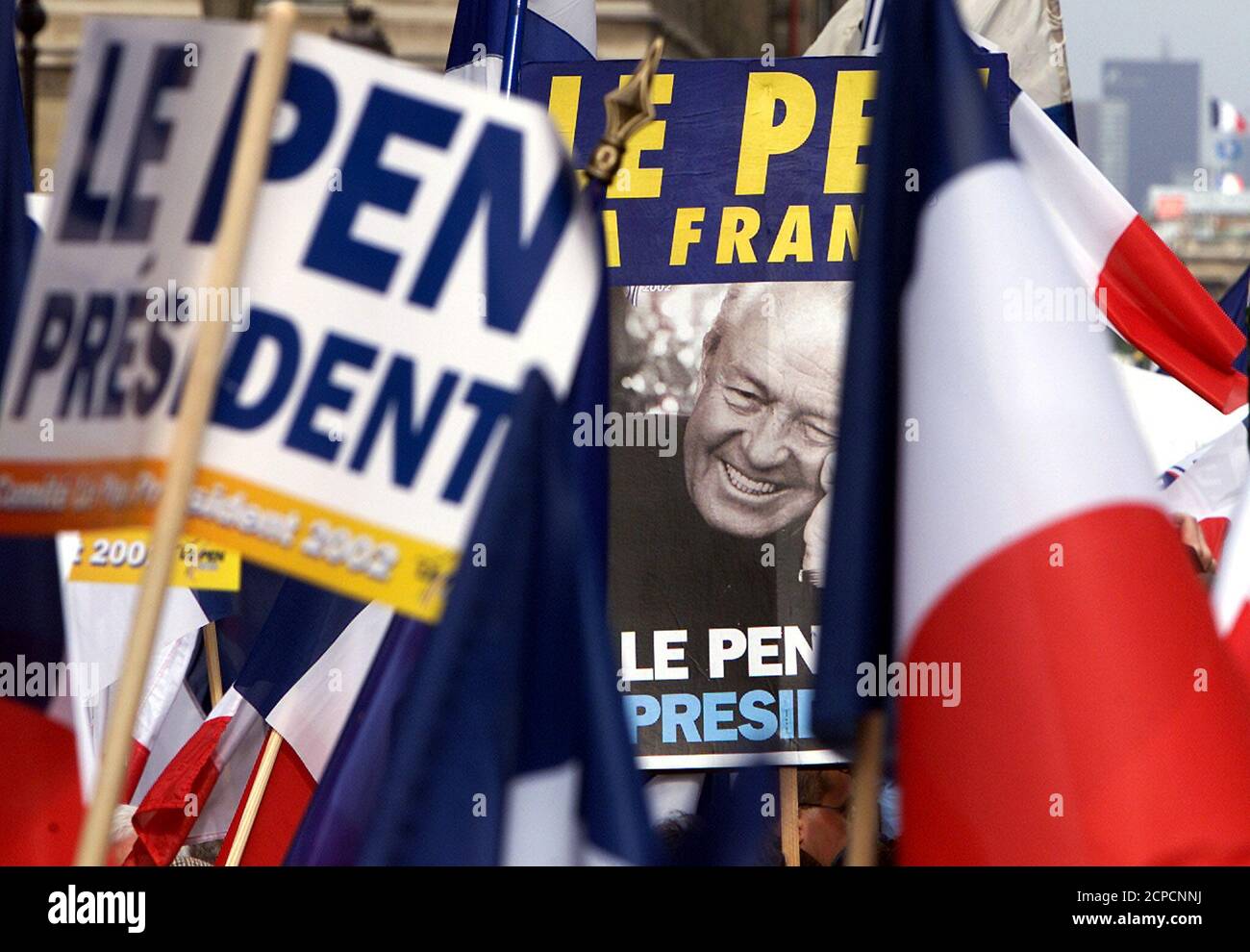 Supporters of French extreme-right National Front presidential candidate  Jean-Marie Le Pen carry flags and campaign posters during a march in Paris,  May 1, 2002. Thousands of supporters join Le Pen for a