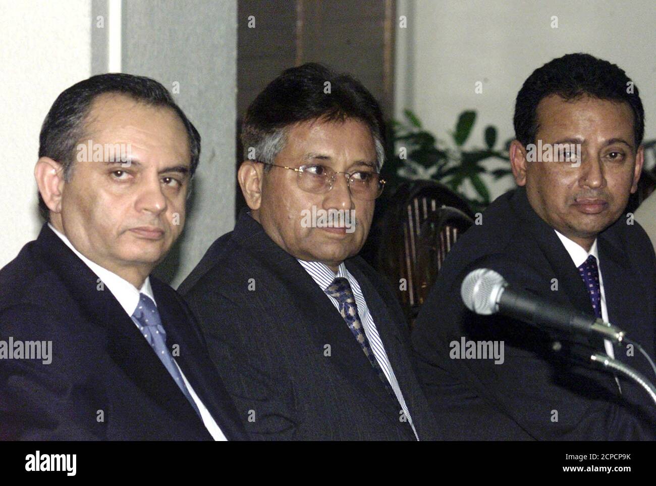 Pakistani President Pervez Musharraf C Flanked By His Commerce Minister Abdul Razzaq Dawood L And Bangladesh Commerce Minister Amir Khasru Mahmud Chowdhury R Attends A Meeting In Dhaka July 30 2002 Musharraf S Expression