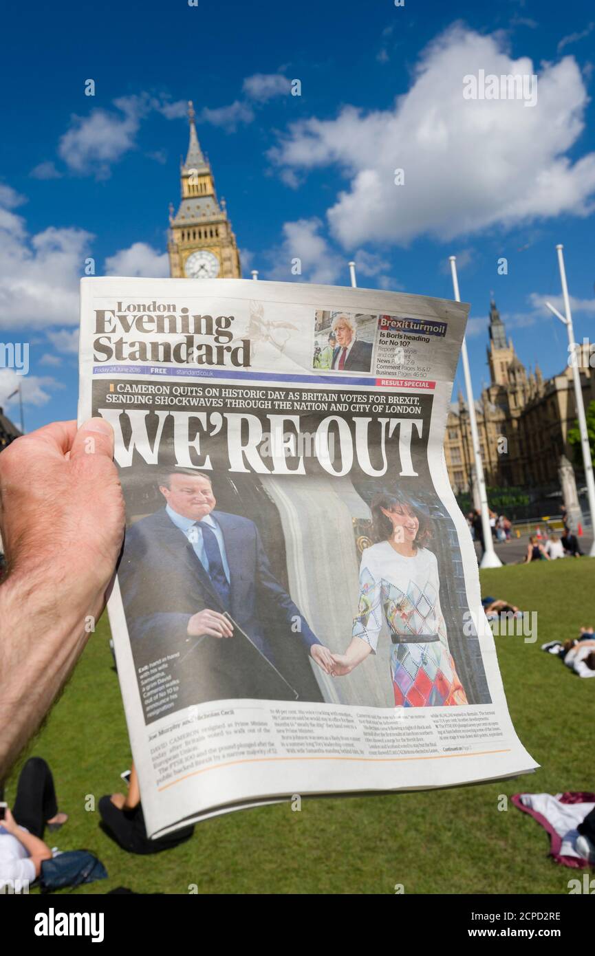 A London Evening Standard Newspaper, with the headline ‘We’re Out’ after Britain voted to leave the European Union, in yesterdays referendum, being held up in front of Houses of Parliament, Parliament Square, Westminster, London, UK.  24 Jun 2016 Stock Photo