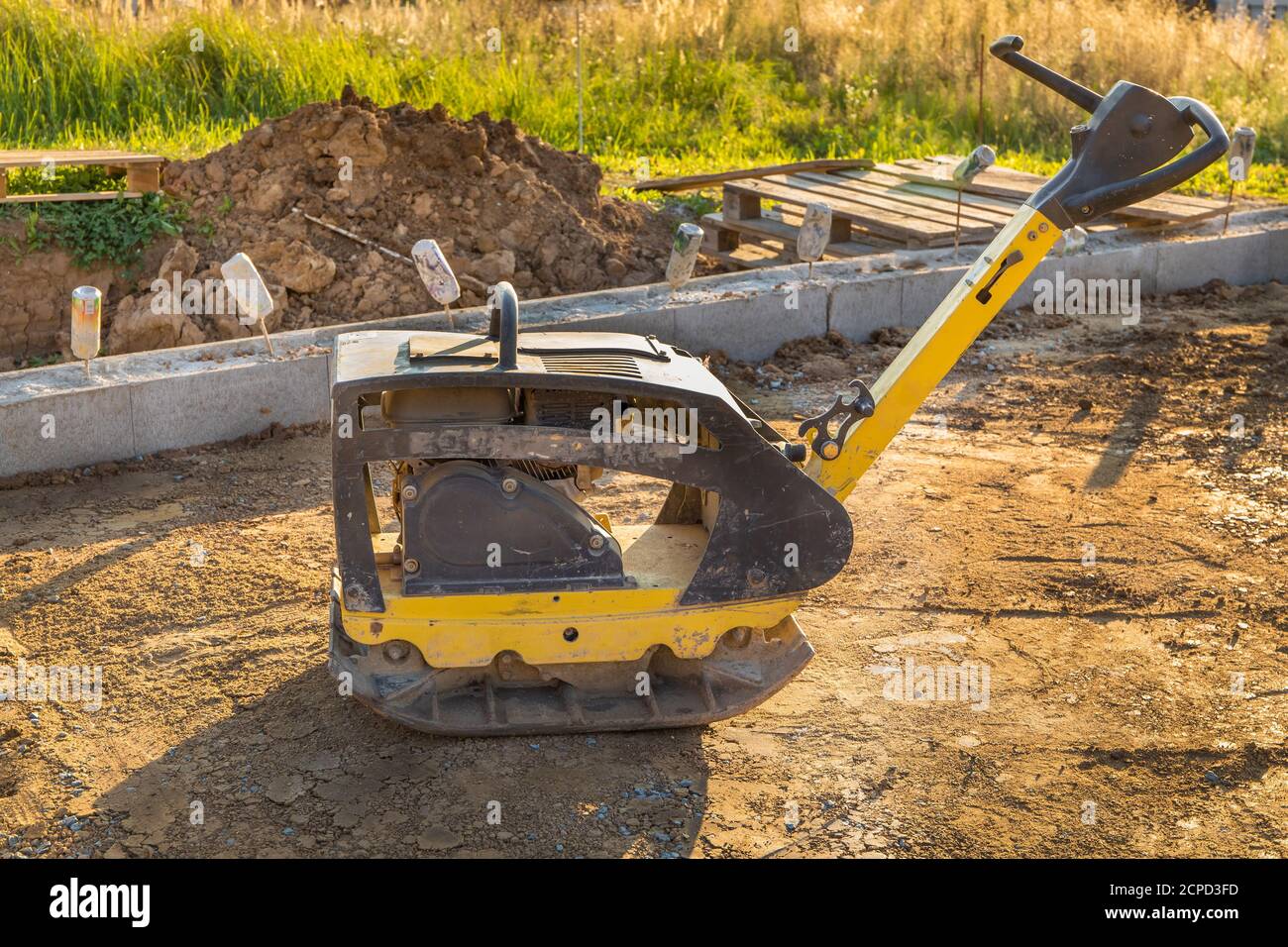 Vibratory plate compactor under construction. Vibratory plate compactor in construction site