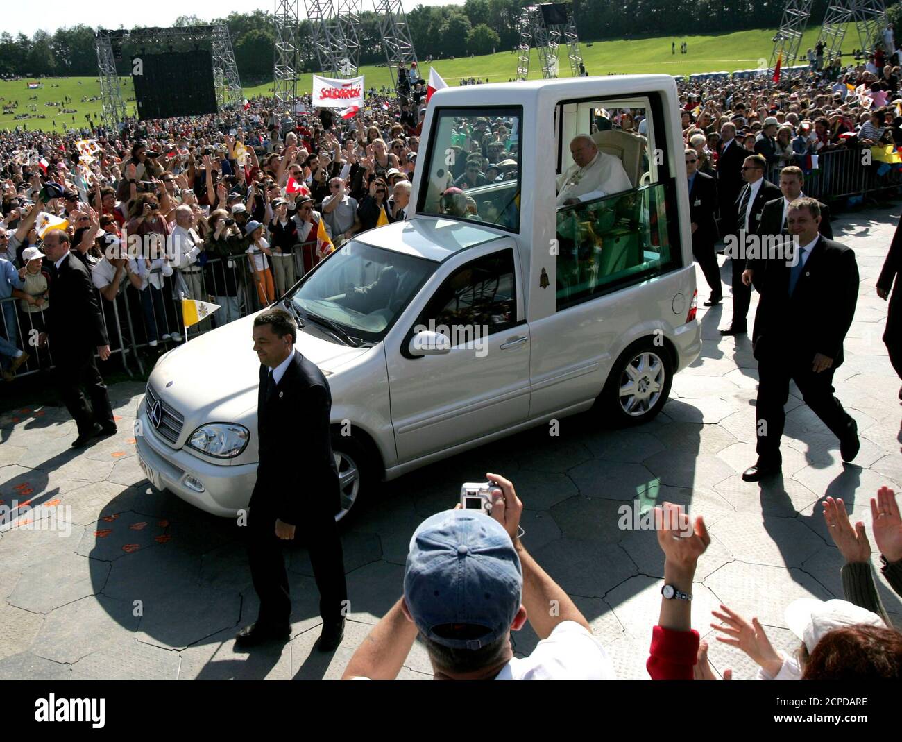 Pope John Paul II arrives on his popemobile to celebrate an open-air mass  in the Allmen Park in Berne June 6, 2004. The ailing 84-year-old pontiff  read mass in a relatively clear