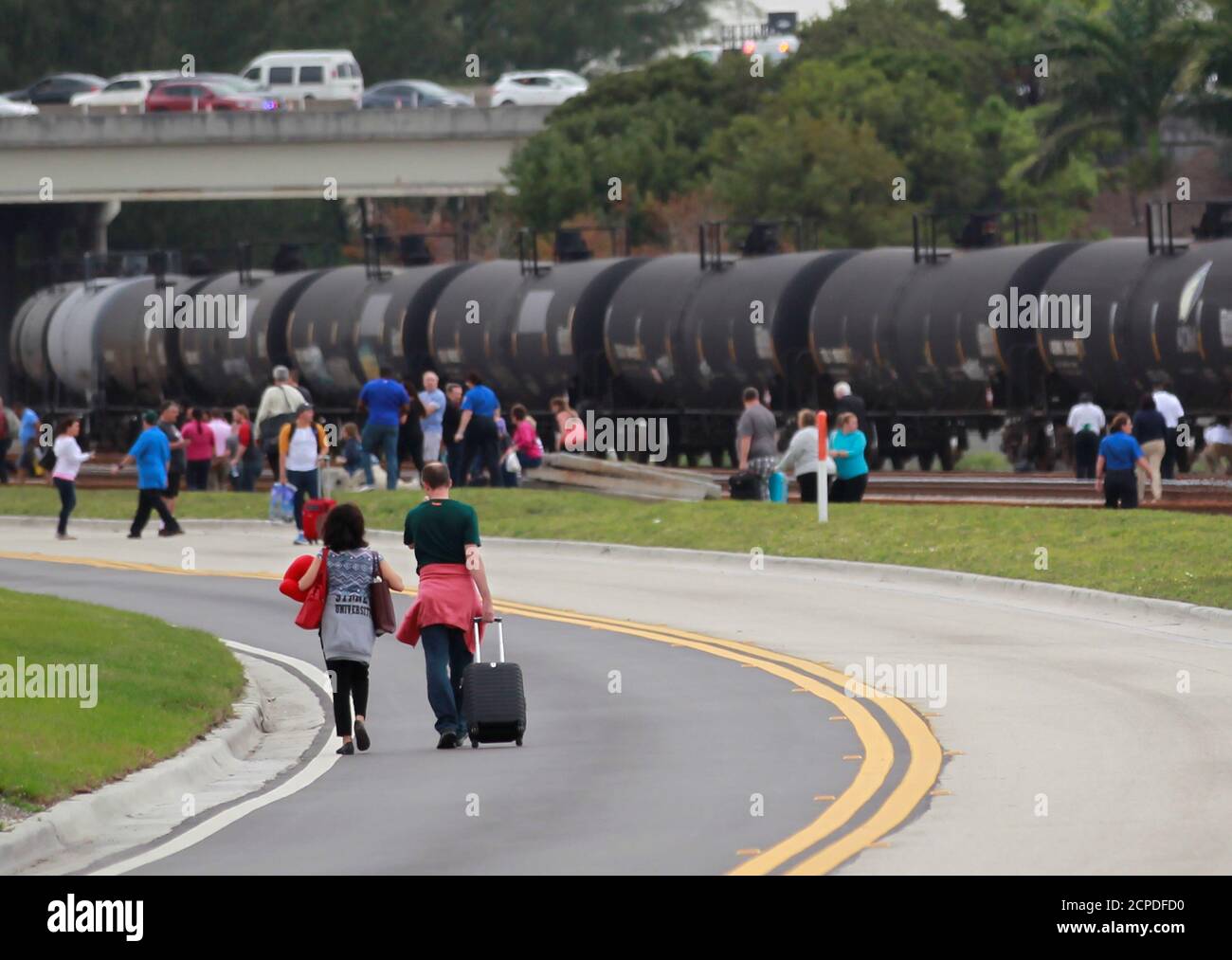 People exit the airport perimeter following a shooting incident at Fort Lauderdale-Hollywood International Airport in Fort Lauderdale, Florida, U.S. January 6, 2017. REUTERS/Andrew Innerarity Stock Photo