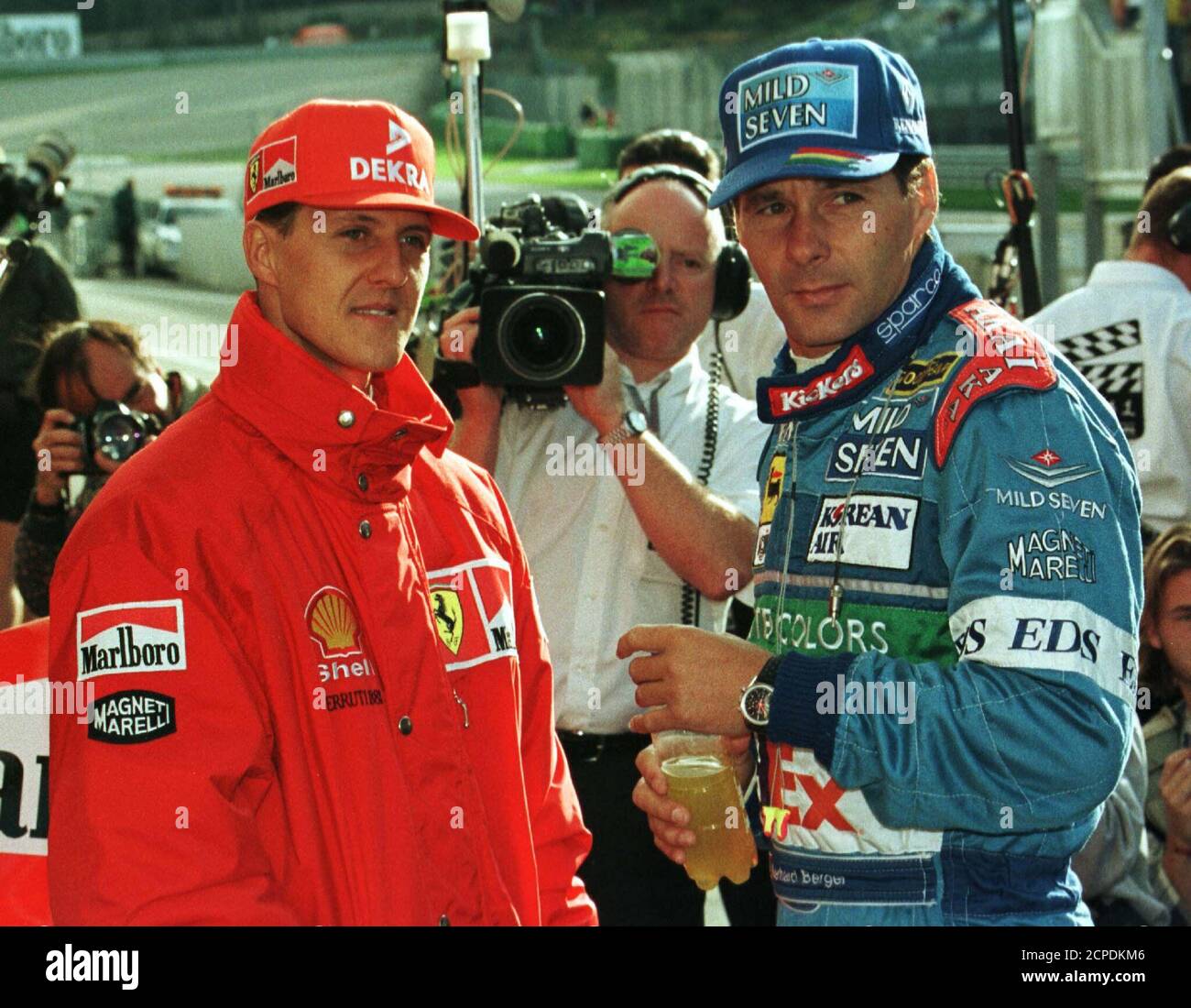 German Ferrari driver Michael Schumacher (L) talks to Austrian Benetton  Renault pilot Gerhard Berger during the second timed session for the  Austrian Grand Prix September 20. Sunday's Grand Prix is the first