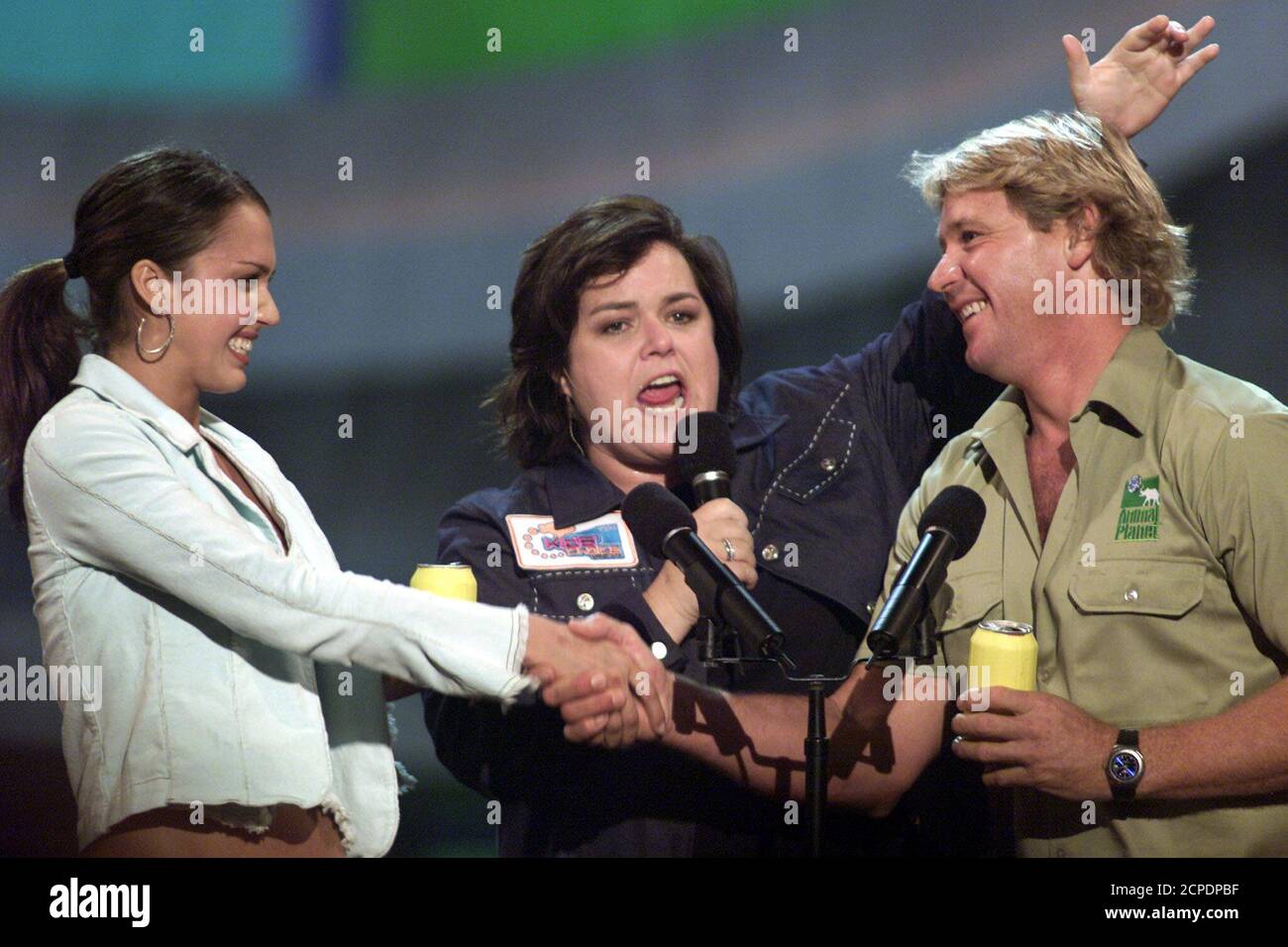 Actress Jessica Alba (L), star of Fox's 'Dark Angel,' shakes hands with Steve Irwin, host of 'The Crocodile Hunter,' as host Rosie O'Donnell announces a tie while presenting the Favorite Burp Award at Nickelodeon's 15th annual Kids' Choice Awards in Santa Monica, California on April 20, 2002. REUTERS/Adrees Latif  AL/SV Stock Photo