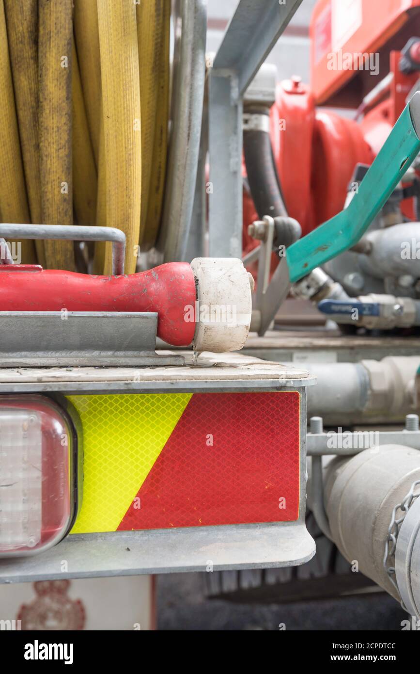 Close up of a fire hose reel, mounted at the rear of a New South Wales Rural Fire Service truck. Water is fed by an onboard generator and water tank Stock Photo