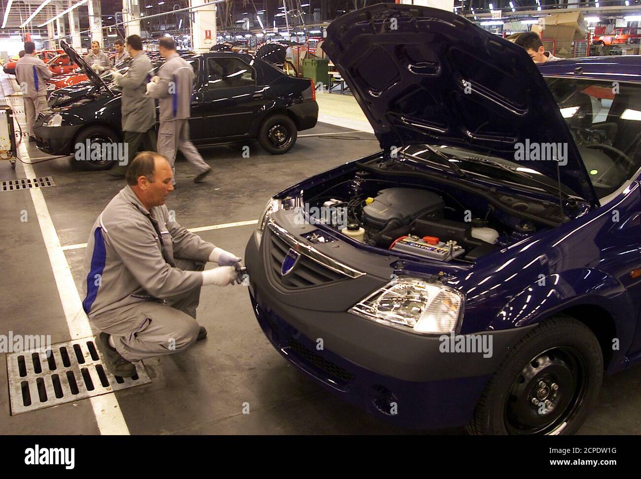 A Romanian worker verifies the hook of a the new Renault-Dacia model called the Logan at the Dacia factory in Mioveni (120 km North-West of Bucharest) June 3, 2004. France's Renault unveiled its no-frills 5,000 euro ($6,139) car on Wednesday as it chases growth in emerging markets to help reach an ambitious target for annual sales of four million vehicles by 2010. REUTERS/Mihai Barbu  BC Stock Photo