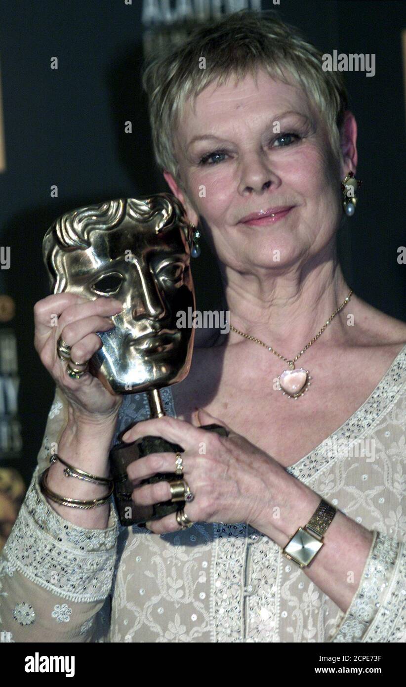 British actress Dame Judi Dench receives the British Academy best actress award for playing another damaged genius with  her memorable portrayal of writer Iris Murdoch 'sliding into the Stock Photo