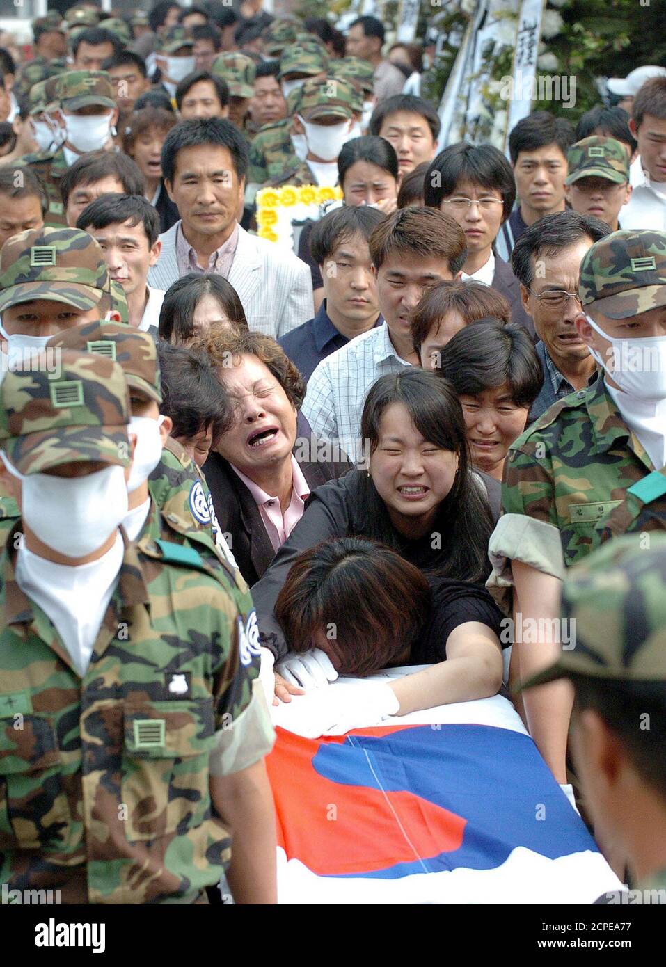 Relatives of soldiers killed during June 19 shooting incident cry during funeral at military hospital in Songnam.  Relatives of soldiers killed during the June 19 shooting incident cry during a funeral at a military hospital in Songnam, about 25 km (16 miles) southeast of Seoul, June 25, 2005. A bullied private, officially identified only as 'Kim', tossed a grenade on June 19, 2005 among barrack comrades and then opened fire, killing 8 soldiers, at a guard post in Yonchon, about 60 km (40 miles) north of Seoul, the Defence Ministry said. REUTERS/Stringer/Pool Stock Photo