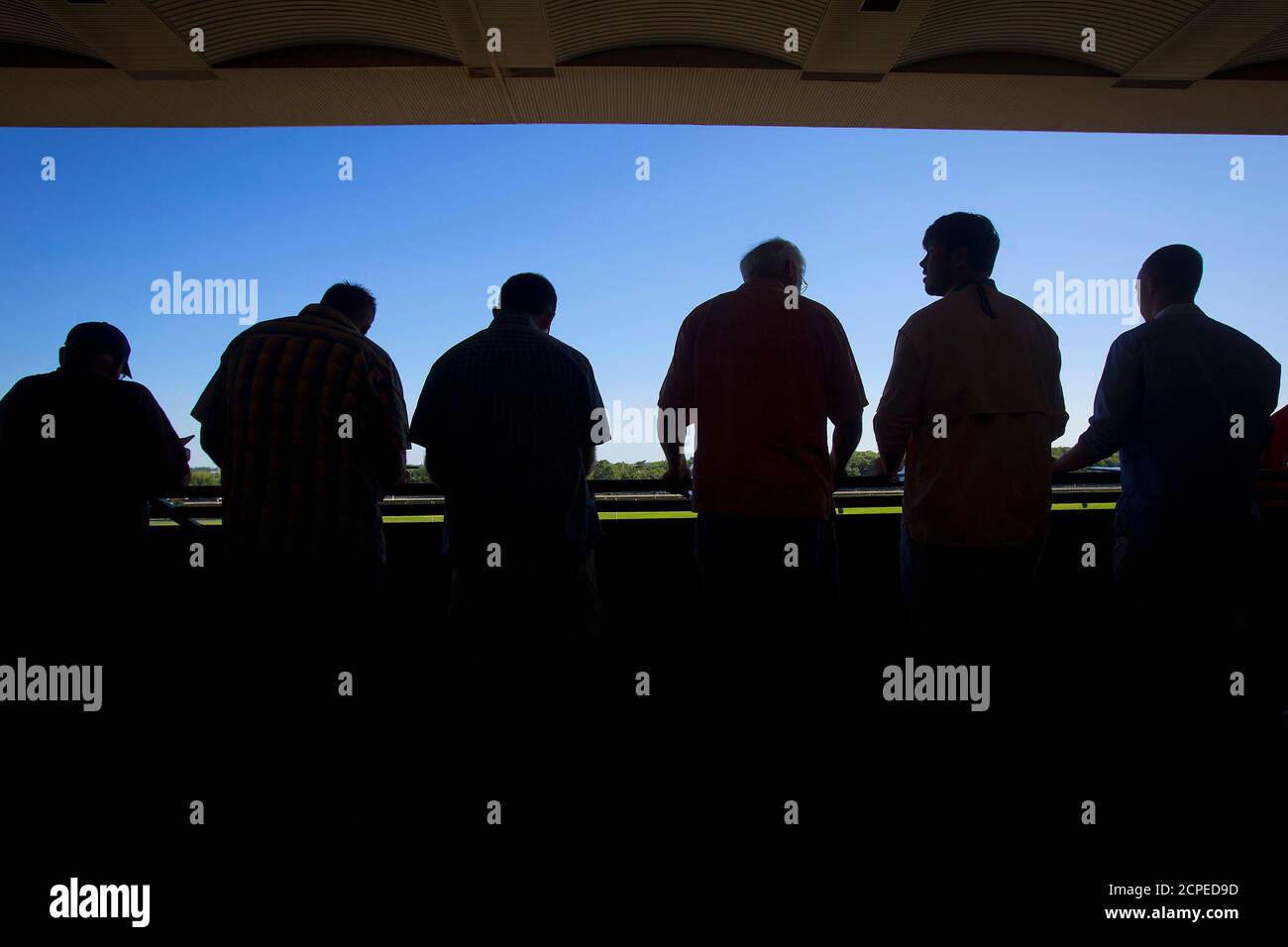 Men line up to watch an early race before the 2014 Belmont Stakes in Elmont, New York June 7, 2014. REUTERS/Carlo Allegri (UNITED STATES - Tags: SPORT HORSE RACING SOCIETY) Stock Photo