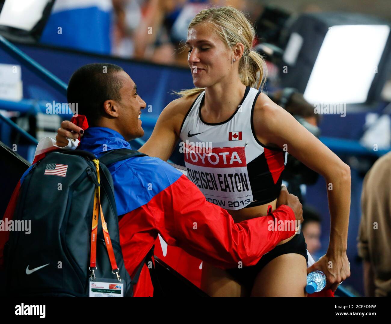 Brianne Theisen Eaton of Canada is embraced by her husband decathlon  Olympic and world champion Ashton Eaton of the U.S. after the women's  heptathlon 800 metres heat event of the IAAF World