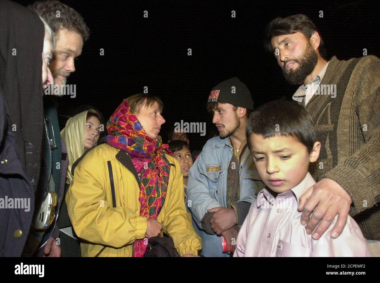 Relatives of victims of the September 11 attacks on Washington and New York, (from left) Rita Lasar, 70, Derrill Bodley, 56, Eva Rupp, 28, and Kelly Campbell, 29, are greeted by Mohammad Shaher (R) and his his son Meellad (2R) in Kabul, January 15, 2002. The Shaher family home was destroyed by a U.S. bomb and Mrs. Shaher, six months pregnant, was severly wounded. Bodley lost his daughter on United Airlines flight 93, Campbell lost her brother-in-law in the Pentagon attack, Rupp lost her step-sister in the United Airlines flight 93 and Lasar's brother was killed at the World Trade Center. Third Stock Photo