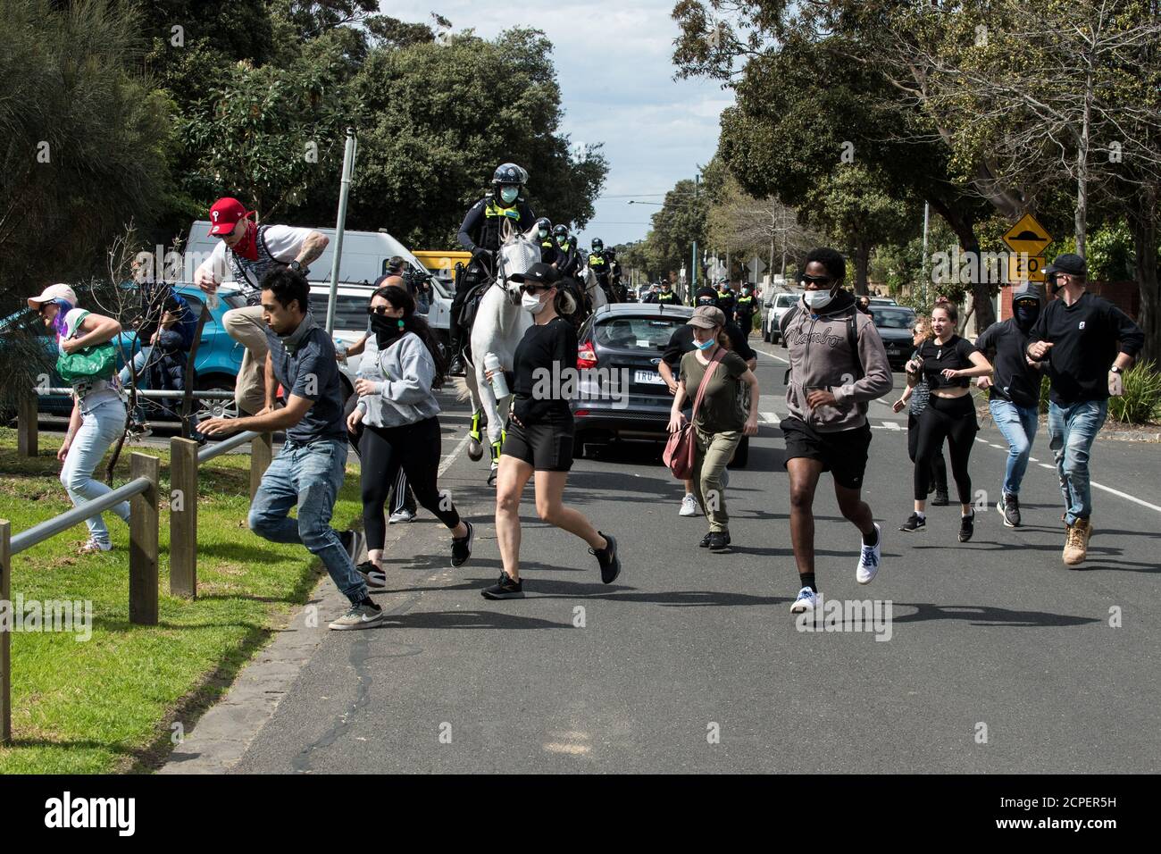 Melbourne, Australia. 19th Sep, 2020. a group of protesters flee from Victoria police mounted officers attempting to cut them off in a beachside street in Elwood after an anti-mask and anti lockdown protest had moved from Elsternwick Park, Melbourne Australia. Credit: Michael Currie/Alamy Live News Stock Photo