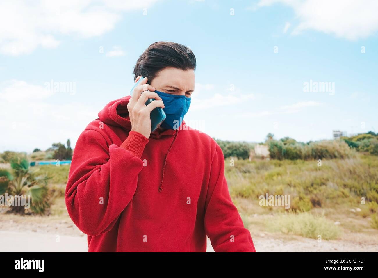 Men using his smartphone with a face mask in Spain Stock Photo Alamy
