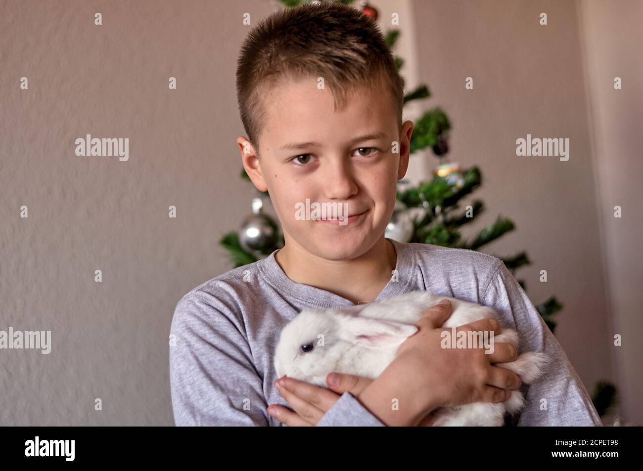 a boy with a white rabbit in his hands Stock Photo - Alamy