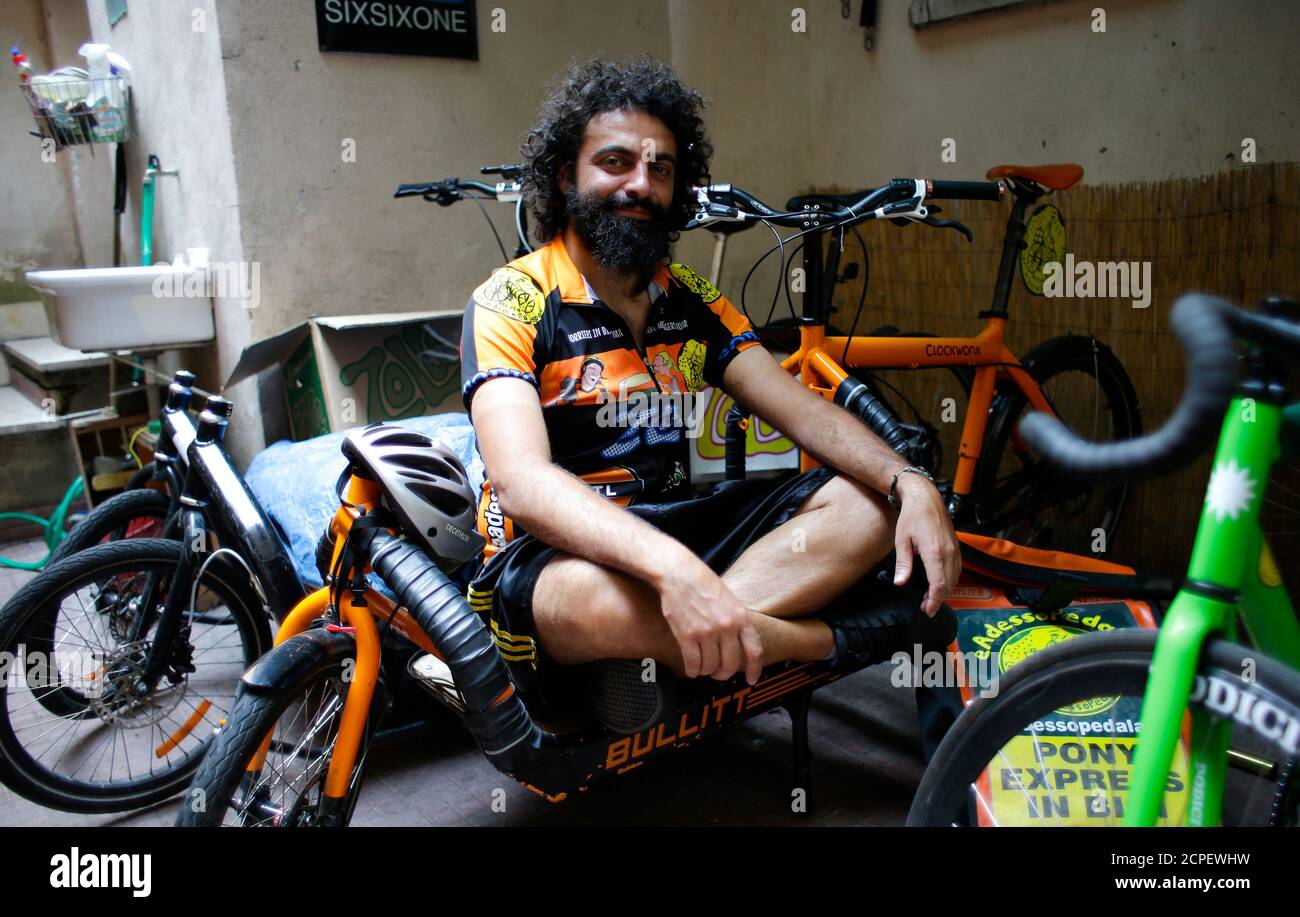 Stefano Pisa of Italy poses for a photo on the premises of bicycle courier company Eadessopedala (And Now Pedal) in Rome, June 27, 2013. Stefano Pisa, 31, has a bachelor of science degree in architecture and earns a monthly salary of 350 euros ($458). He lives with his parents as he has no enough money to rent an apartment. Eadessopedala, which was founded in 2008 by Hungarian businessman Tomas-Laszlo Simon, currently has an annual turnover of about 100,000 euros ($130, 300) and employs 12 Italians. According to an April 2 poll from the Milan Chamber of Commerce, small businesses led by foreig Stock Photo