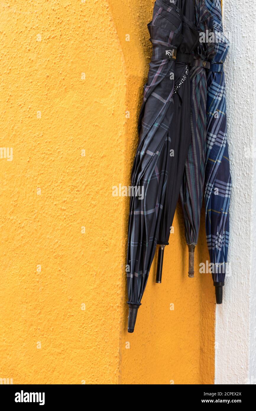 close up of a colored pipe line on the external wall of a house in Burano island, Venice, Veneto, Italy Stock Photo