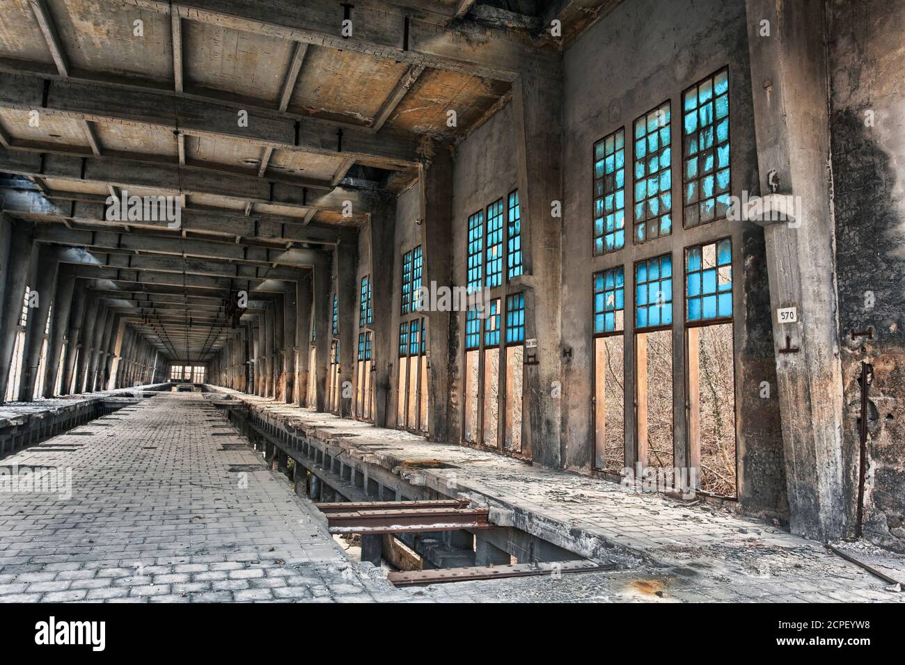 old abandoned industrial building with blue windows, industrial ruins, disused factory Stock Photo
