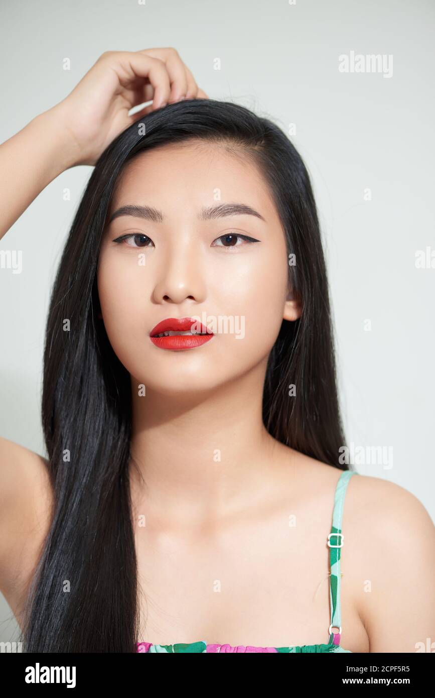 Beautiful woman asian face close up studio .She is catching hair Stock Photo