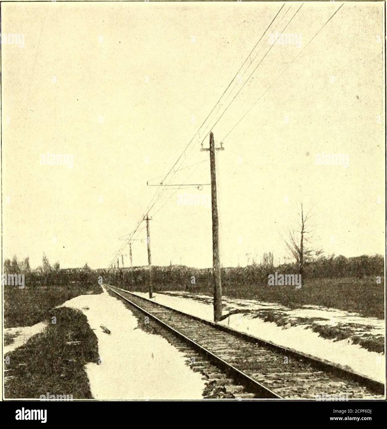 . The Street railway journal . or a pressure of 6600 volts.The trolley is No. 000 grooved wire, and is suspended froma 7/16-in. seven-strand galvanized steel messenger cable bymeans of galvanized-iron trolley hangers, spaced approxi-mately 10 ft. apart. These hangers consist of short lengthsof pipe threaded at one end and flattened and punched atthe other. The threaded end engages in a socket which fitsover the threaded portion of two drop-forged steel lugs,which engage in the groove of the trolley wire. Thepunched end of the hanger is secured to the messenger cableby means of a strap-iron cla Stock Photo