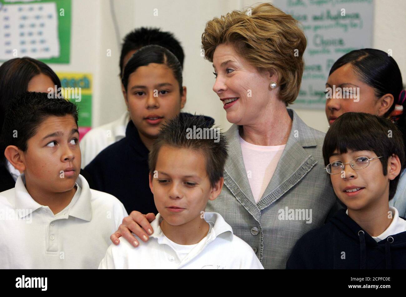 U.S. first lady Laura Bush poses with students during her visit to language classes at Sun Valley Middle School in Los Angeles, California April 27, 2005. REUTERS/Lucy Nicholson  LN Stock Photo