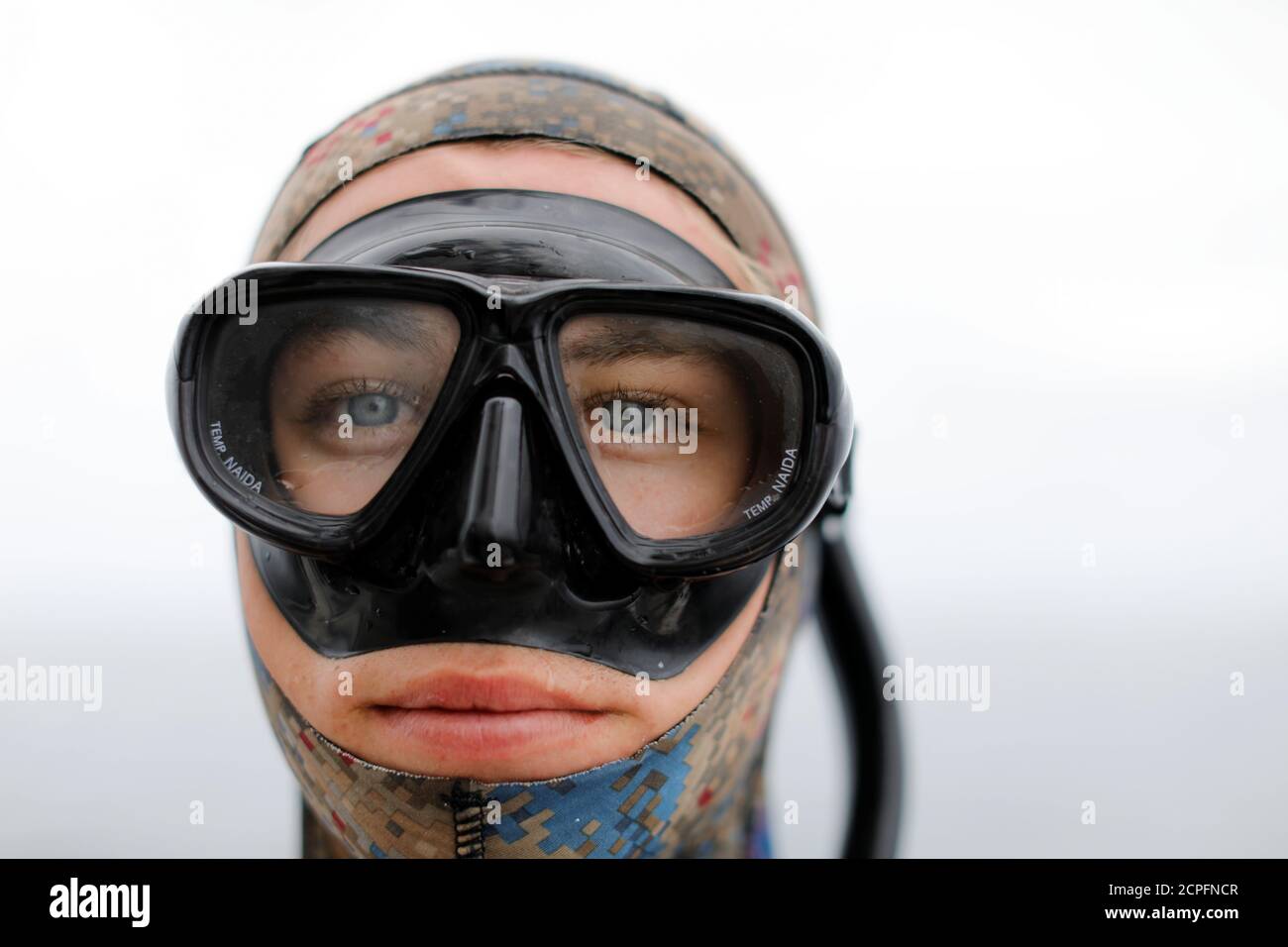 Ryder Devoe,19, looks out from his dive mask before free diving for large  Pacific bluefin