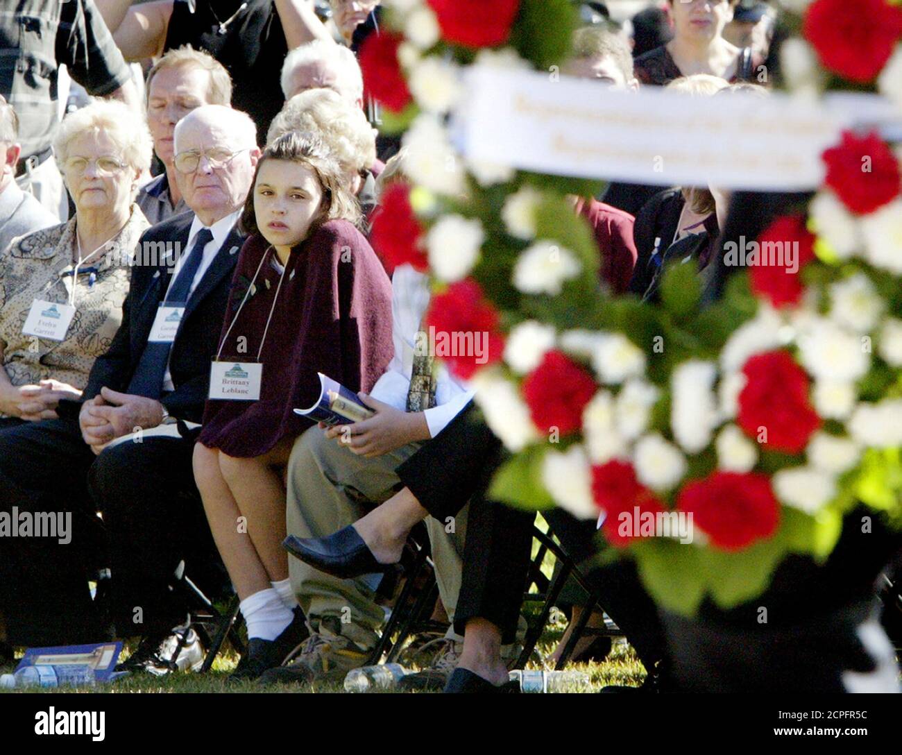 Evelyn Garrett and Gordon Garrett, parents of deceased Cobourg Police Constable Christopher Garrett, watch along with Constable Garrett's stepdaughter, Brittany Leblanc, as a wreath is laid during the 27th Annual Police Memorial Service.  Evelyn Garrett (L) and Gordon Garrett (C), parents of deceased Cobourg Police Constable Christopher Garrett, watch along with Constable Garrett's stepdaughter, Brittany Leblanc, as a wreath is laid during the 27th Annual Police Memorial Service on Parliament Hill in Ottawa, September 26, 2004. Constable Garret was murdered while answering an alleged robbery c Stock Photo