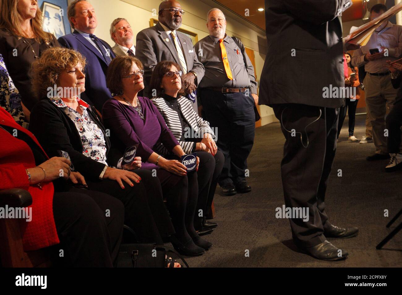 North Carolina's Electors listen as Republican Party Executive Director Dallas Woodhouse (right) speaks to the media after he helped gather them for a group photo before they rehearsed for tomorrow's electoral college vote in Raleigh, North Carolina, U.S., December 18, 2016.     REUTERS/Jonathan Drake Stock Photo