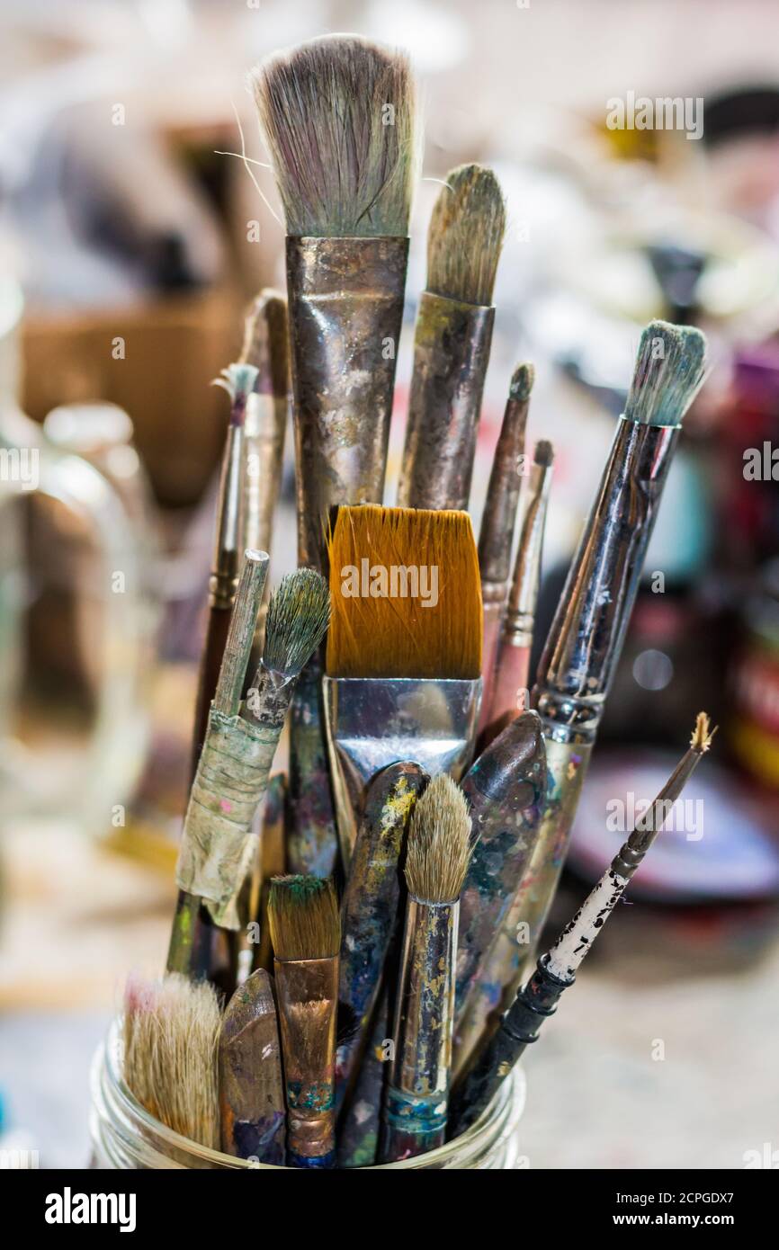 Artist's paint brushes in a jar taken in the artist's studio Stock