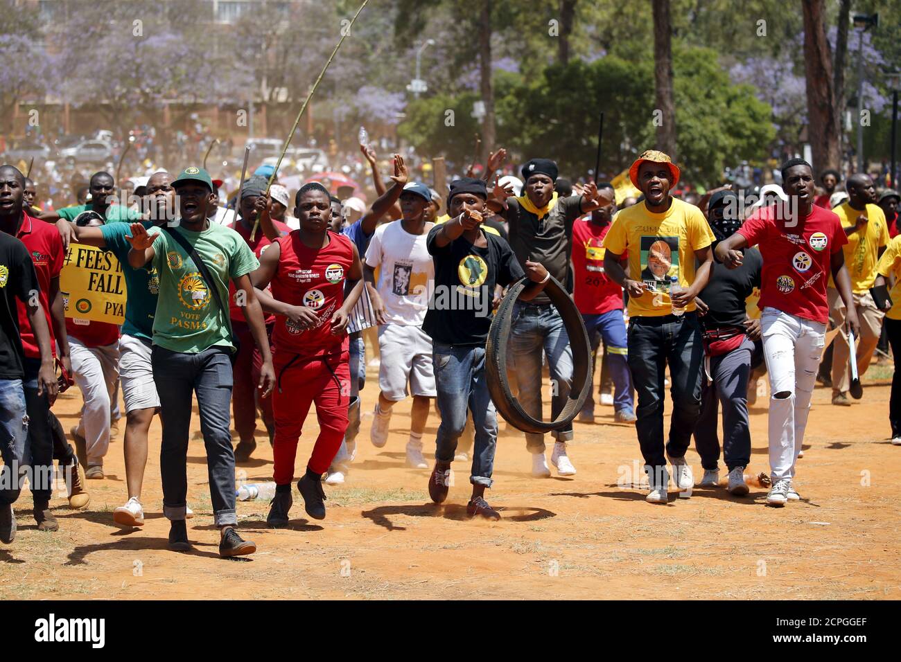 Demonstrators gesture at a photographer during a protest over planned increases in tuition fees outside the Union building in Pretoria, South Africa October 23, 2015. South police fired stun grenades at