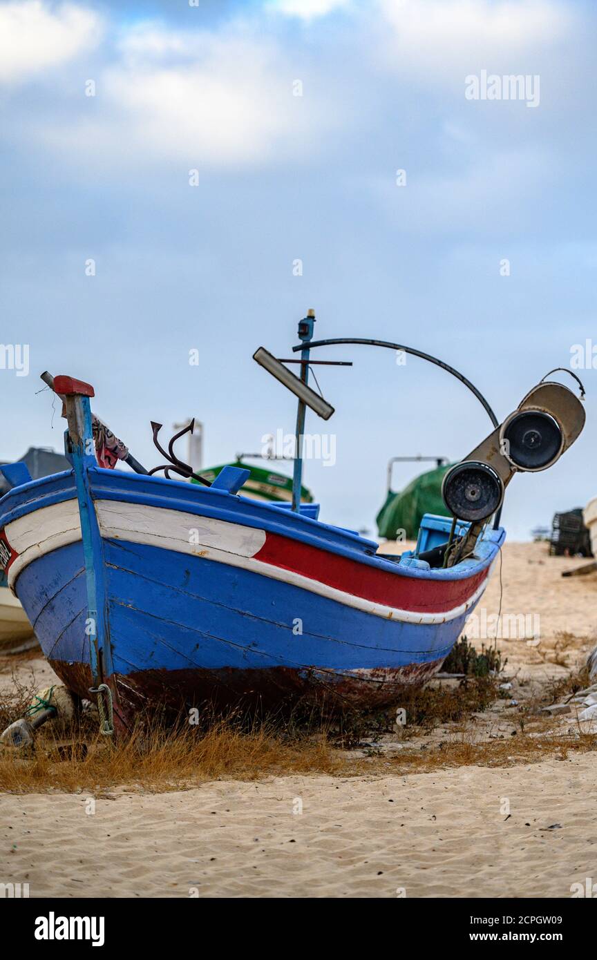 Vertical shot of an old weathered fishing boat on a beach sand Stock ...