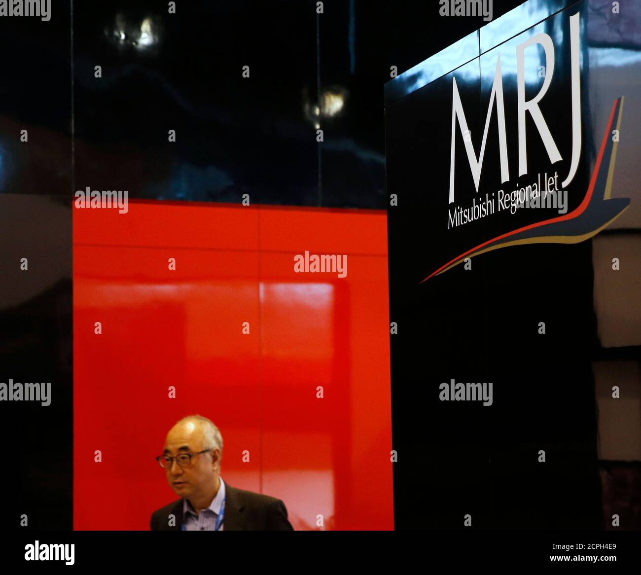 The logo of Mitsubishi Regional Jet (MRJ) is seen at the Mitsubishi Regional Jet booth during the opening day of the Singapore Airshow at Changi Exhibition Center February 16, 2016. Mitsubishi Aircraft Corp, a unit of Mitsubishi Heavy Industries Ltd, has struck a deal to supply 20 regional jets to U.S. leasing firm Aerolease, its first agreement with a lessor. REUTERS/Edgar Su Stock Photo