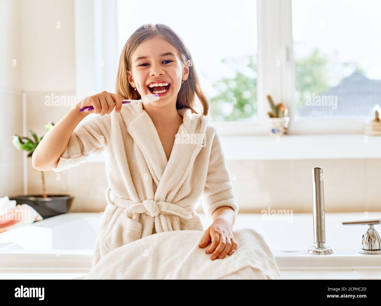 Child girl is brushing teeth toothbrush in the bathroom Stock Photo Alamy