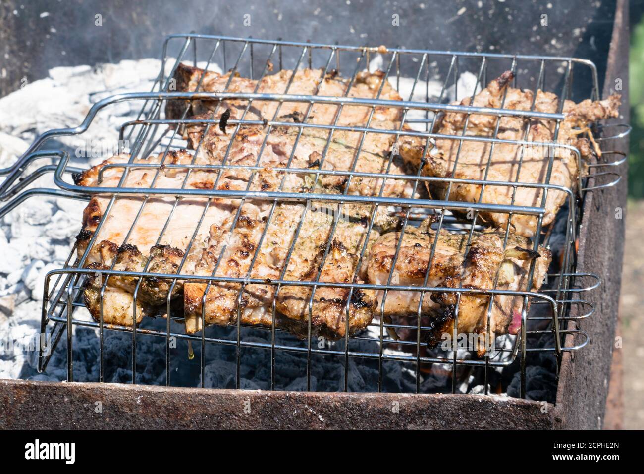 grilled meat on the charcoal grill. Embers smoke ash Stock Photo - Alamy