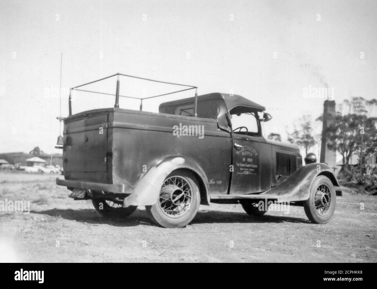 A Sydney County Council, English made1935 Morris 8 vehicle with a most likely Australian made utility chassis and soft top cabin cover. This was a Council District Operator's vehicle that carried wooden ladders on the passenger side which wasn't a problem because it was used by only one driver/worker at a time. The location of the shot is unavailable but may be near Rhodes in Sydney where the driver of the vehicle lived at the time. The vehicle had a small search light mounted on the drivers door and was in radio contact with head office. Stock Photo