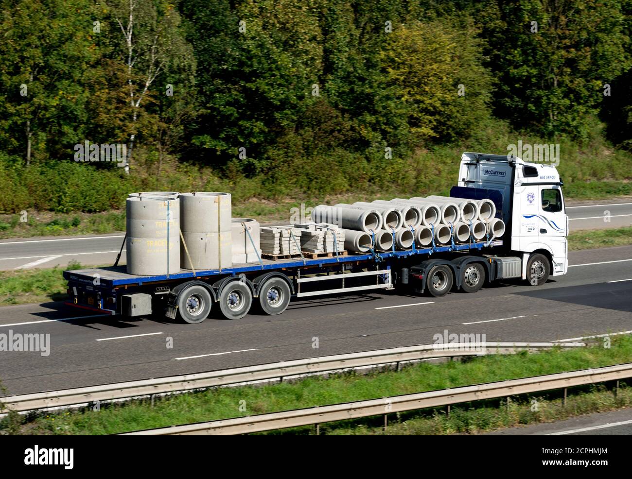 Concrete pipes transported on the M40 motorway, Warwickshire, UK Stock Photo