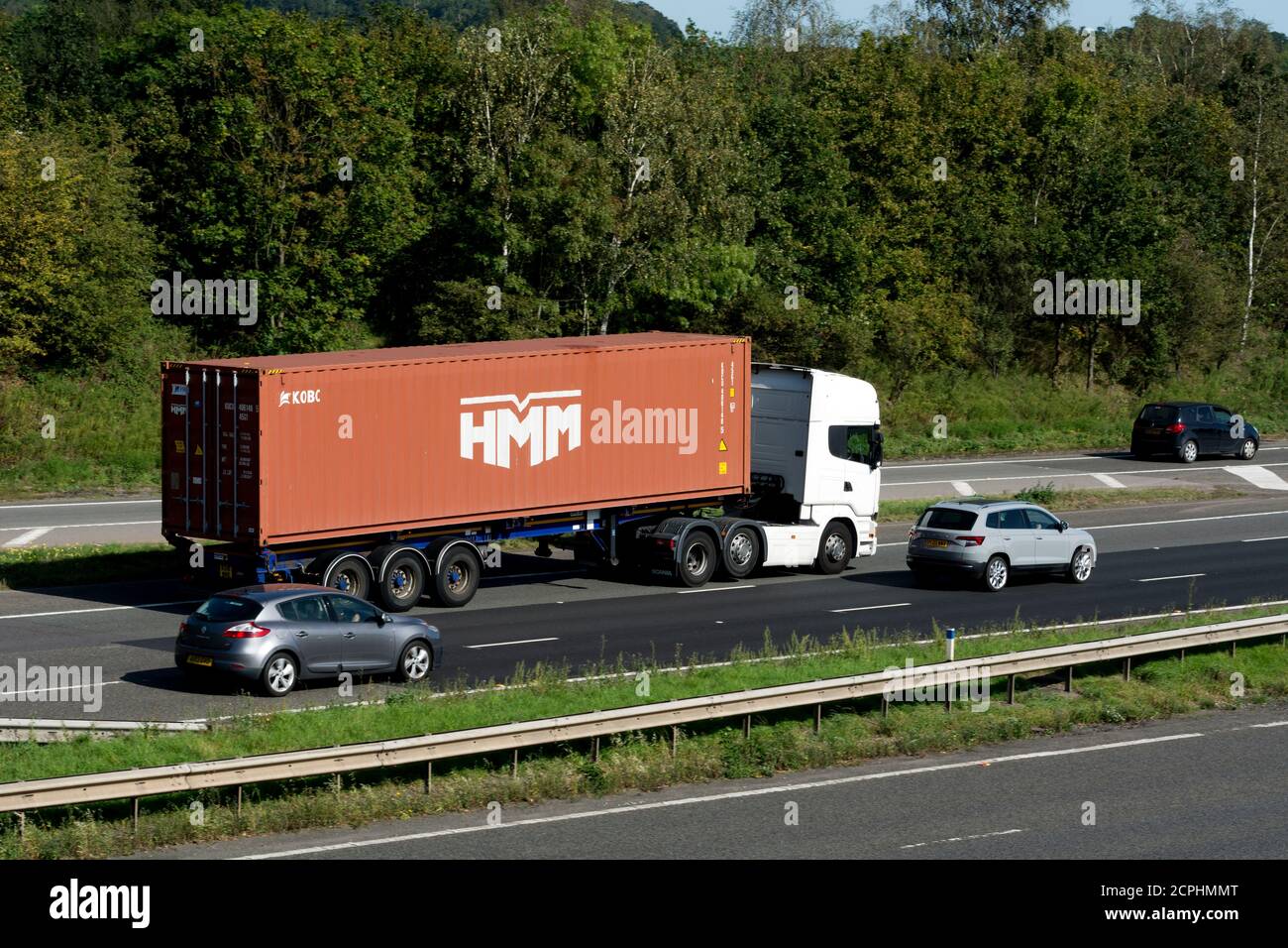 HMM shipping container transported on the M40 motorway, Warwickshire, UK Stock Photo