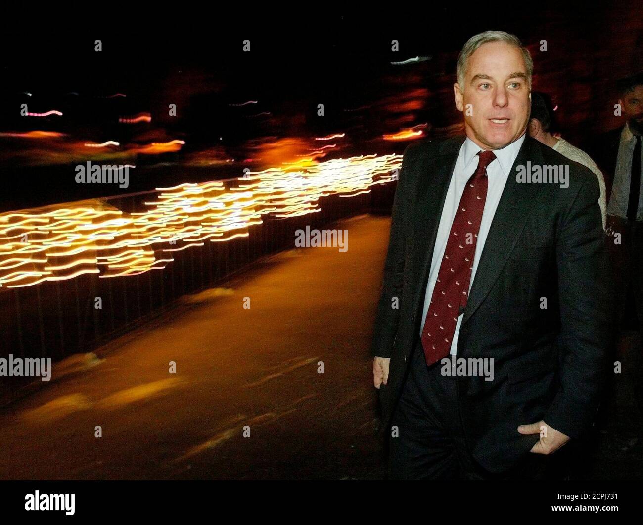 U.S. Democratic presidential candidate Howard Dean rushes past a light display outside a hotel after speaking along with other Democratic candidates at the New Hampshire Democratic Party's '100 Club Dinner' in Nashua, New Hampshire January 24, 2004. REUTERS/Jim Bourg  JRB Stock Photo
