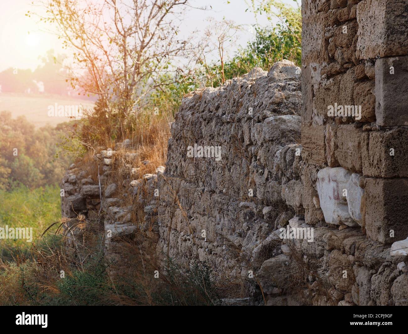 Fragment of an ancient building from the 15th century AD. Blurred background. Ancient ruins of the 15th century in the morning sun. Israel. Stock Photo
